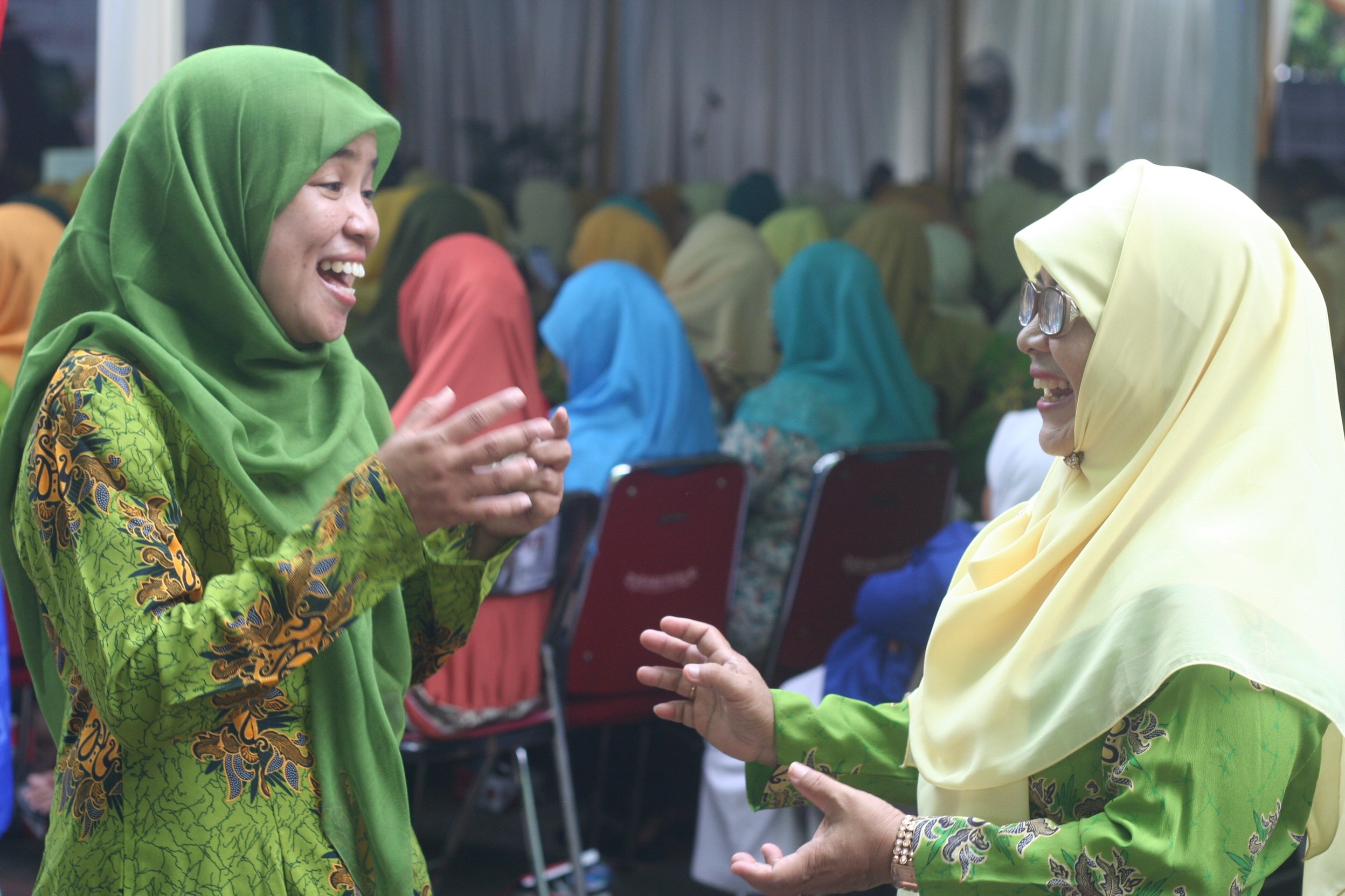 Acha (left) catches up with Ema, an Aisyiyah volunteer.