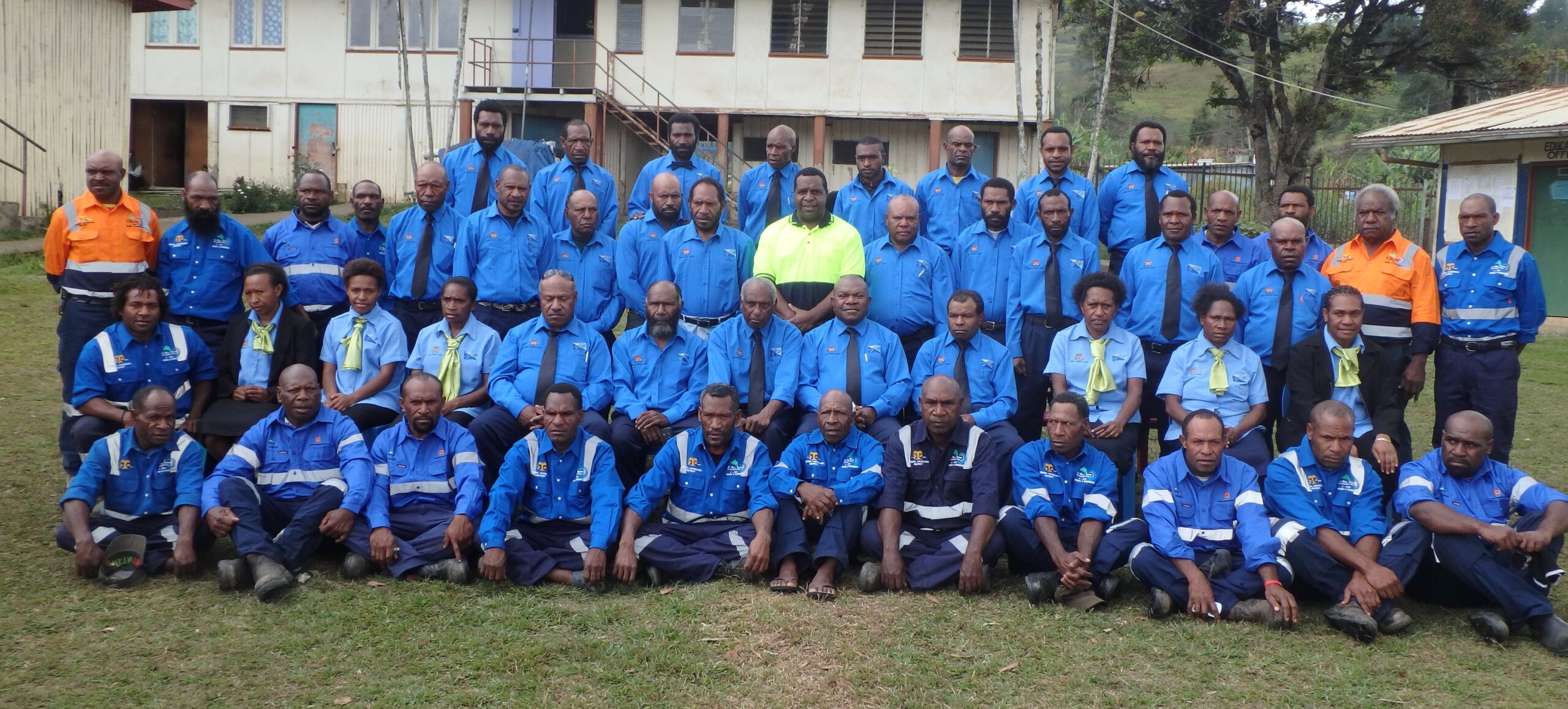 The MP for Obura Wonenara (The Honorable Mehrra Kipefa) [at centre, in high-vis top] with the District Development Authority Board and District Administration Team, in their newly issued uniforms, December 2015 (image: Bennie Atigini, CARE PNG)