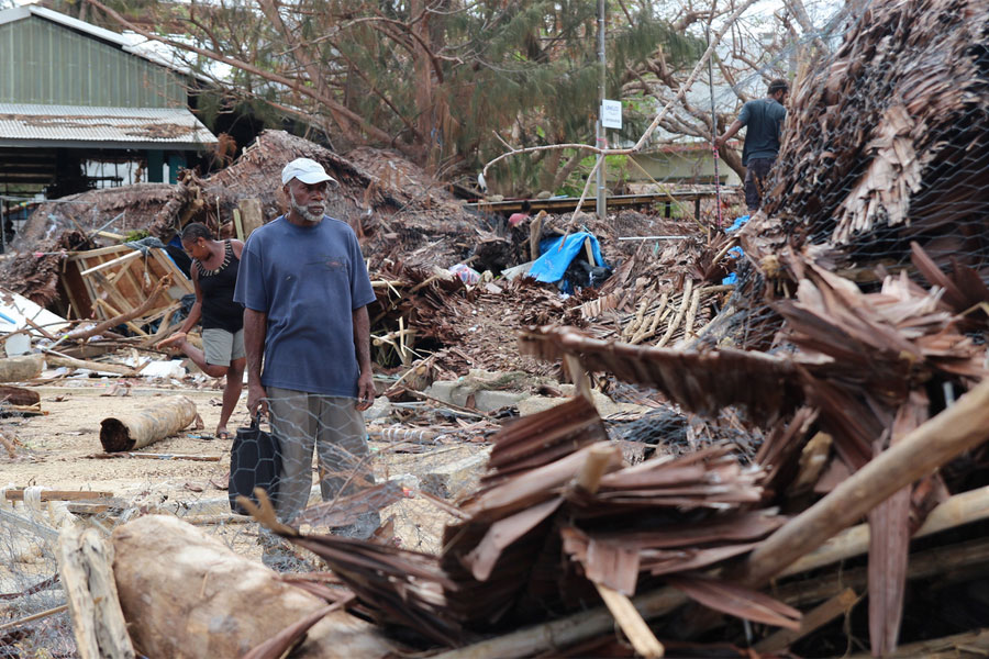 Market traders in Port Vila look through the debris left by Cyclone Pam (image: Mark Mitchell for Caritas Aotearoa New Zealand)