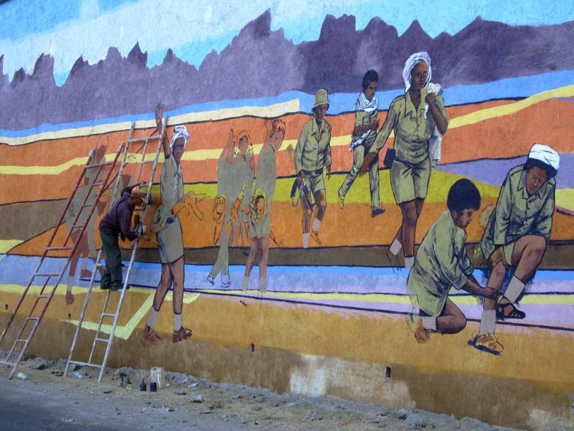 An artist prepares a patriotic mural by the road between Asmara and Keren, Eritrea (David Stanley/Flickr CC BY 2.0)