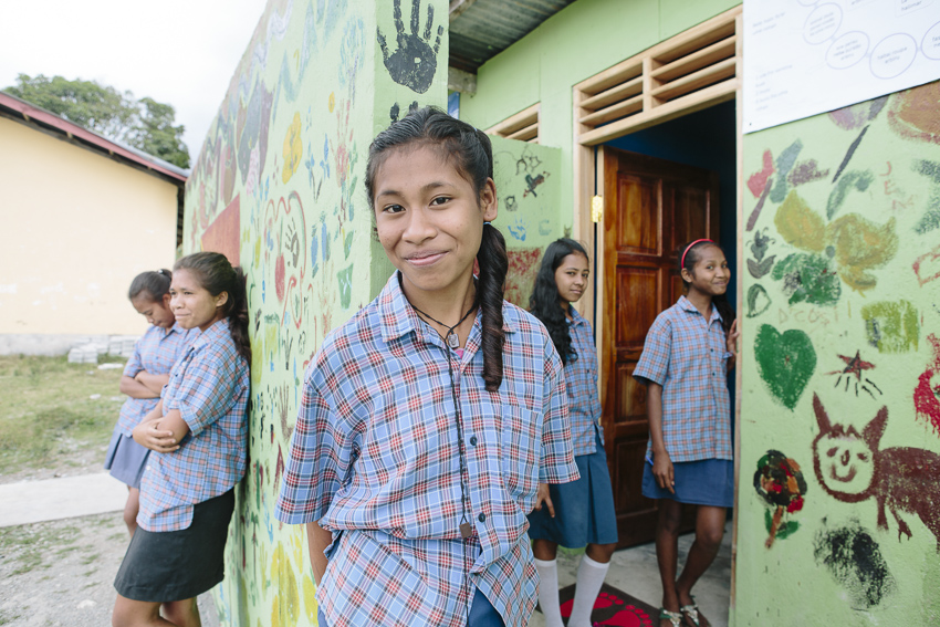 Etelvina Vita Da Costa, 15 (centre), outside the new toilet block at Ailuli Pre-Secondary School in Same, Manufahi District, Timor-Leste (WaterAid/Greenwood)