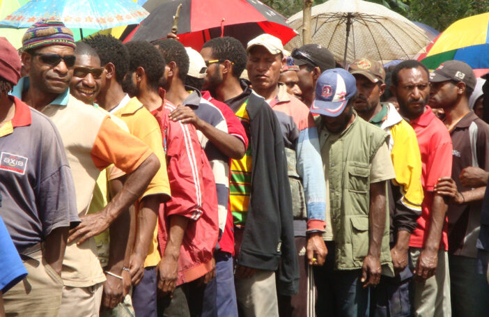 Men queue to vote in 2012 (Treva Braun/Commonwealth Secretariat/Flickr CC BY-NC-ND 2.0)