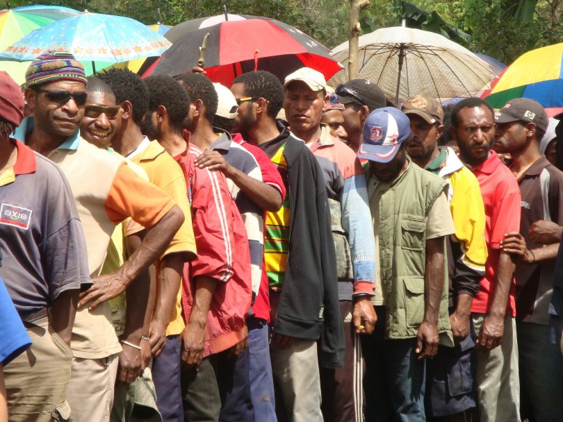 Men queue to vote in 2012 (Treva Braun/Commonwealth Secretariat/Flickr CC BY-NC-ND 2.0)