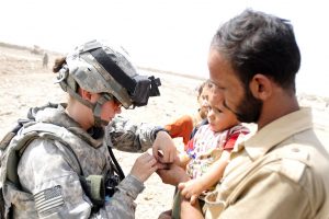 Medic bandaging child's finger (Spc. Jared Eastman/US Army/Flickr CC-BY 2.0)