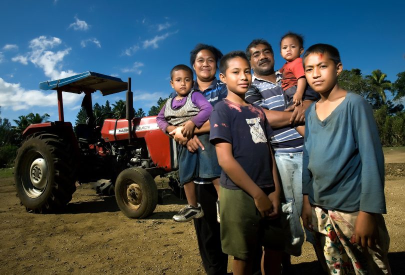 A farming family standing in front of their tractor in Nuku'alofa, Tonga (Asian Development Bank/Flickr/CC BY-NC-ND 2.0)