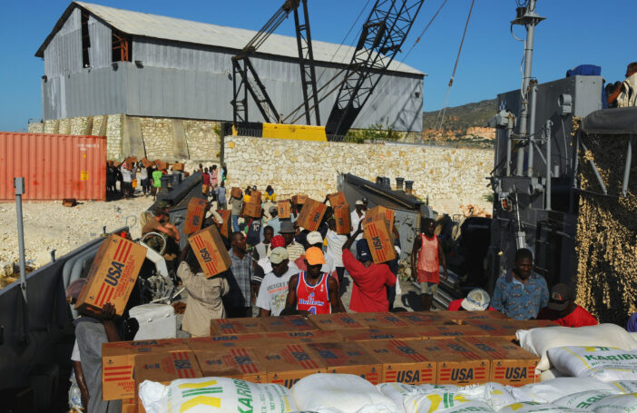 Haitian civilians unload relief supplies from a US Navy ship (Marion Doss/Flickr/CC BY-SA-2.0)