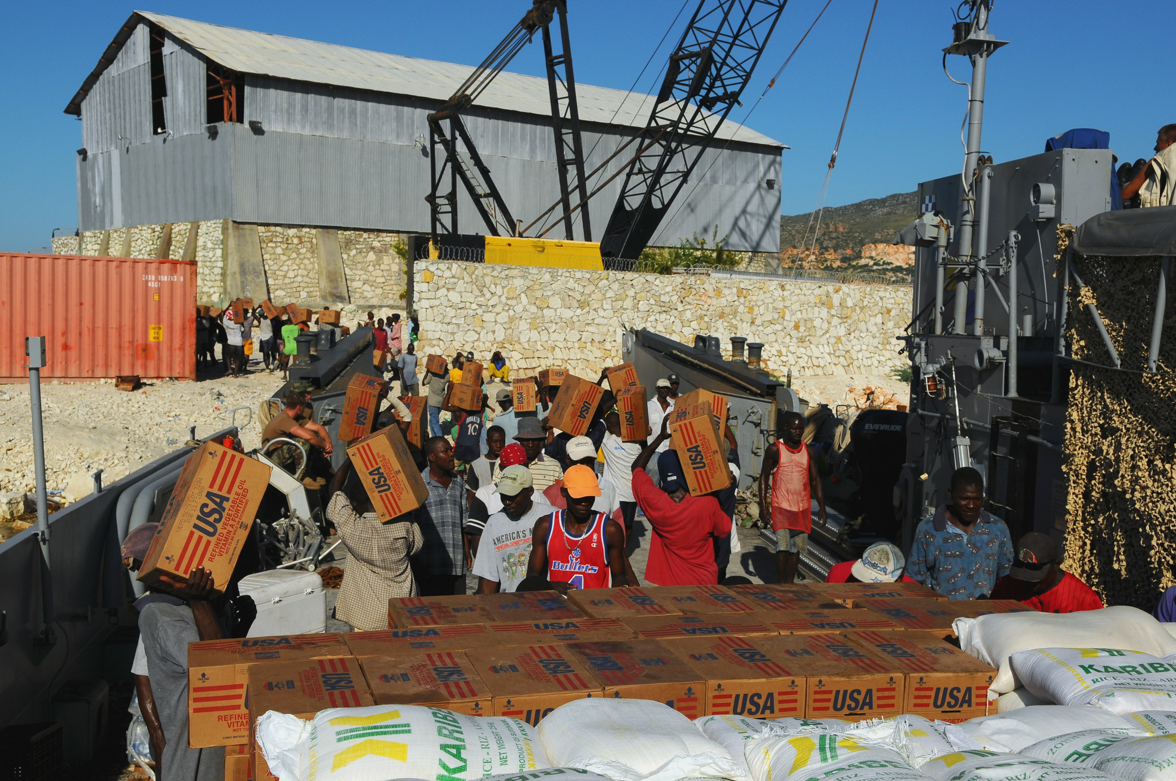Haitian civilians unload relief supplies from a US Navy ship (Marion Doss/Flickr/CC BY-SA-2.0)
