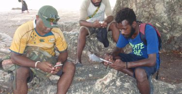 UPNG students using their mobile phones (Credit: Amanda Watson)