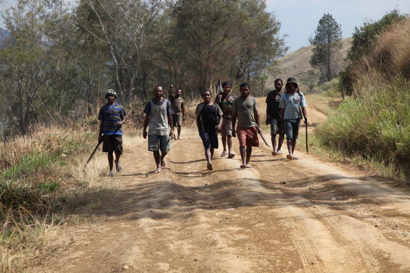 Young men in Eastern Highlands, PNG engaged in tribal conflict walking to meet the opposing tribe (DFAT/Flickr/CC BY 2.0)