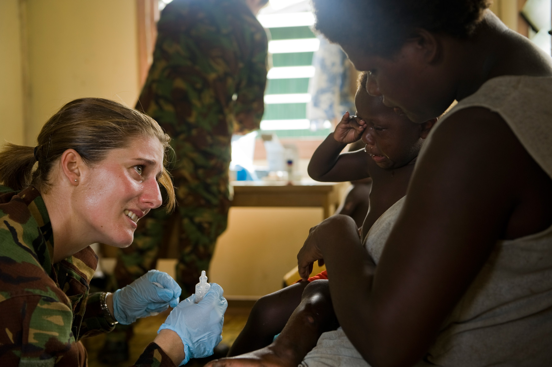 A New Zealand Army officer treats a child at the patrol's temporary medical clinic in Mbarama village, Solomon Islands (New Zealand Defence Force/Flickr/CC BY-2.0)