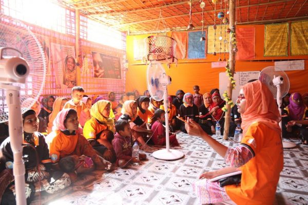 Women take part in group discussions at UNFPA-supported Women Friendly Space in a refugee camp in Cox's Bazar, Bangladesh (Credit: Melissa Lukdeke/UNFPA)