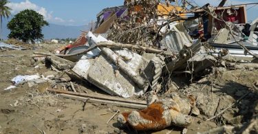 A mud-covered teddy bear lies among a pile of debris following the recent tsunami in Indonesia (Credit: ABC News/Ari Wuryantama)