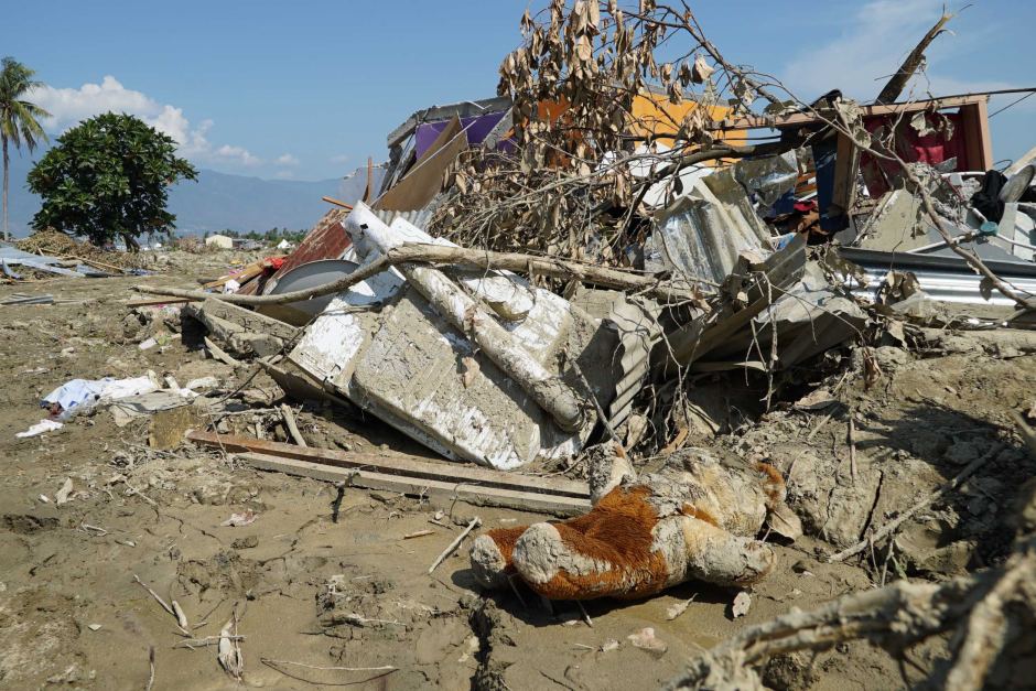 A mud-covered teddy bear lies among a pile of debris following the recent tsunami in Indonesia (Credit: ABC News/Ari Wuryantama)
