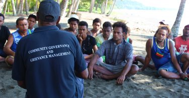 Community Officer Daniel Danegu speaks with young men in Kokana village, Makira, Solomon Islands (Credit: World Bank)