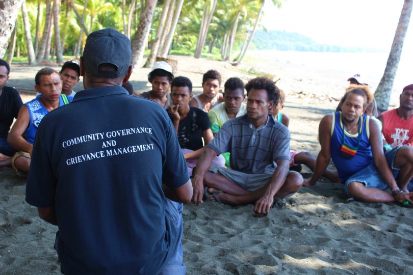 Community Officer Daniel Danegu speaks with young men in Kokana village, Makira, Solomon Islands (Credit: World Bank)
