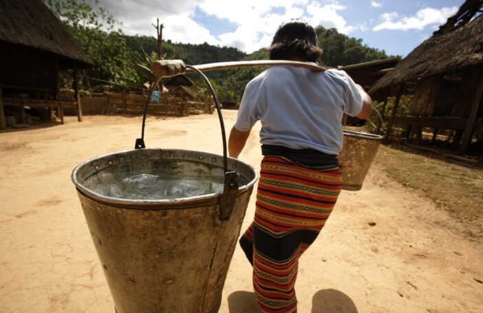 Carrying water in Lao PDR (Credit: DFAT/Flickr CC BY 2.0)