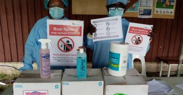 Health workers with PPE, posters and sanitizers donated by ADI in New Ireland