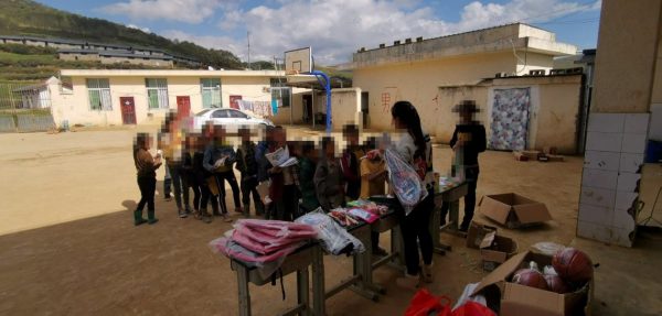 Students lining up to receive school supplies (Huiyuan Liu)