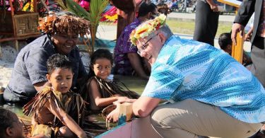 Scott Morrison at the 2019 Pacific Islands Forum meeting children who were sitting in water to demonstrate the danger of rising sea levels due to climate change (Pacific Islands Forum/Twitter)