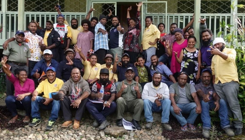 Extension officers from Coffee Industry Corporation and leaders from farmer groups attending strongim grup training in Aiyura, December 2019 (image supplied by the authors).