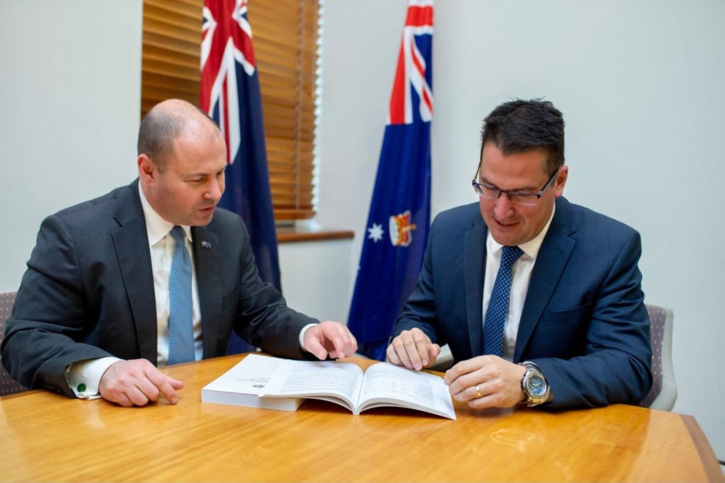 The Treasurer and Minister for International Development looking over the 2021 budget papers
