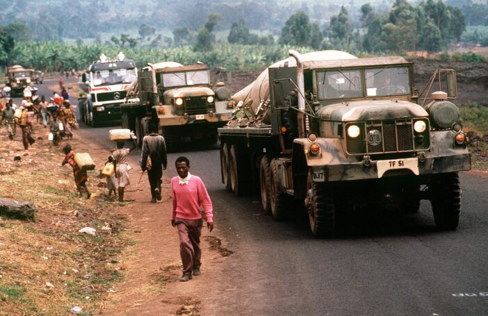 Convoy of US military vehicles carrying fresh water to Rwandan refugees at camp Kimbumba, Zaire in August 1994