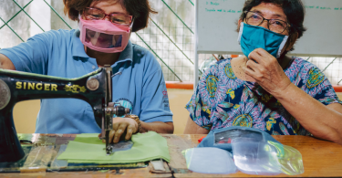 Marietta Cadigal (left), Inclusive Disaster Risk Reduction Motivator at Edmund Rice Ministries in Southern Leyte, Philippines, sewing inclusive face masks (CBM)
