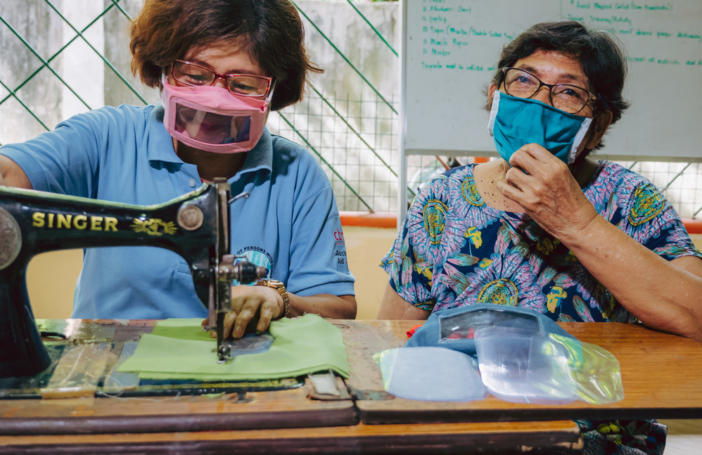 Marietta Cadigal (left), Inclusive Disaster Risk Reduction Motivator at Edmund Rice Ministries in Southern Leyte, Philippines, sewing inclusive face masks (CBM)