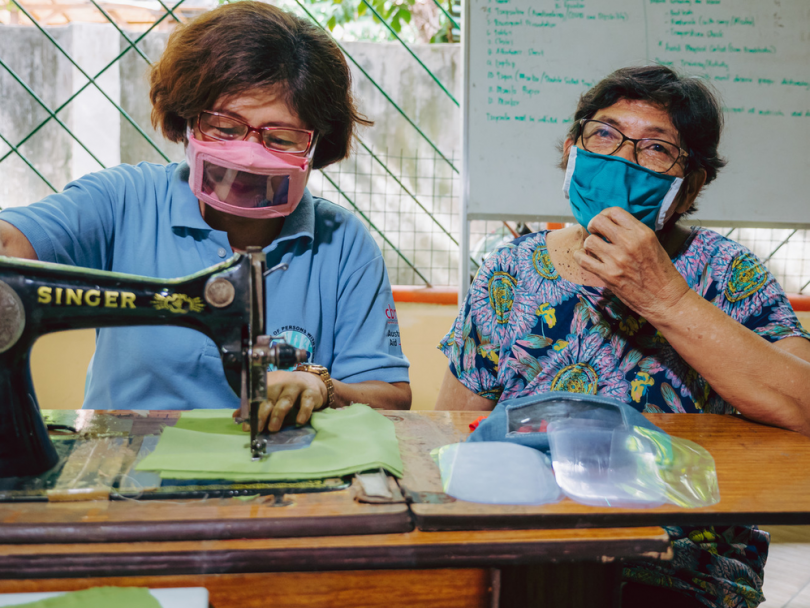 Marietta Cadigal (left), Inclusive Disaster Risk Reduction Motivator at Edmund Rice Ministries in Southern Leyte, Philippines, sewing inclusive face masks (CBM)