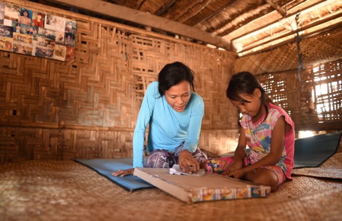 A mother helping her child learn from home (INOVASI)