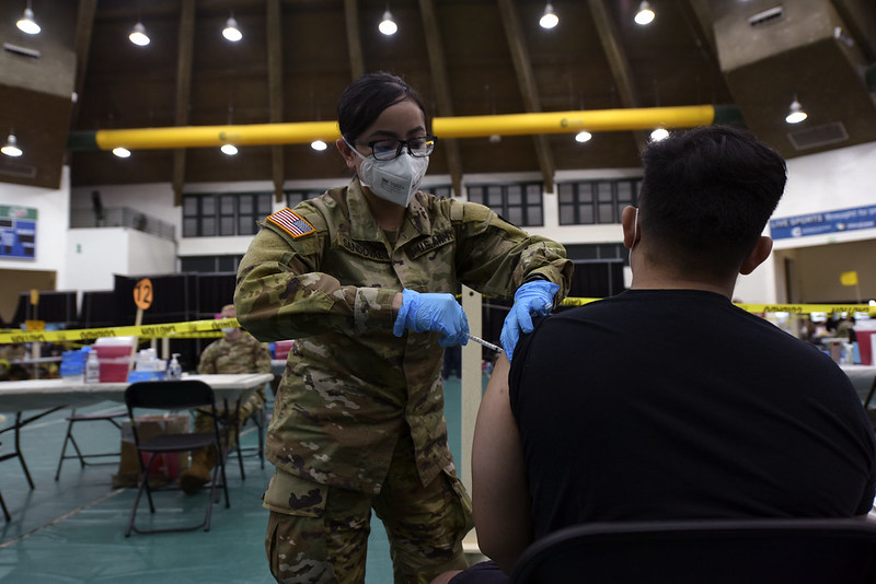 A US infantry officer administers a COVID-19 vaccine in Guam