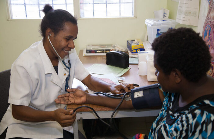 Rose (mother) and toddler in the treatment room at Susa Mama health clinic, Port Moresby General Hospital, PNG