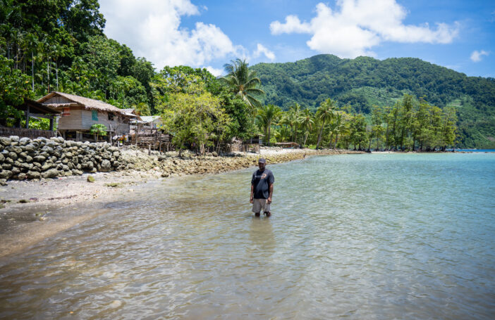 Martin Hau’ato stands where there used to be dry land and houses of Muki Community in the Solomon Islands (Ivan Utahenua-Oxfam)