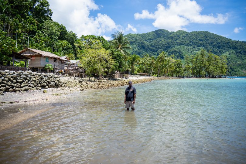 Martin Hau’ato stands where there used to be dry land and houses of Muki Community in the Solomon Islands (Ivan Utahenua-Oxfam)