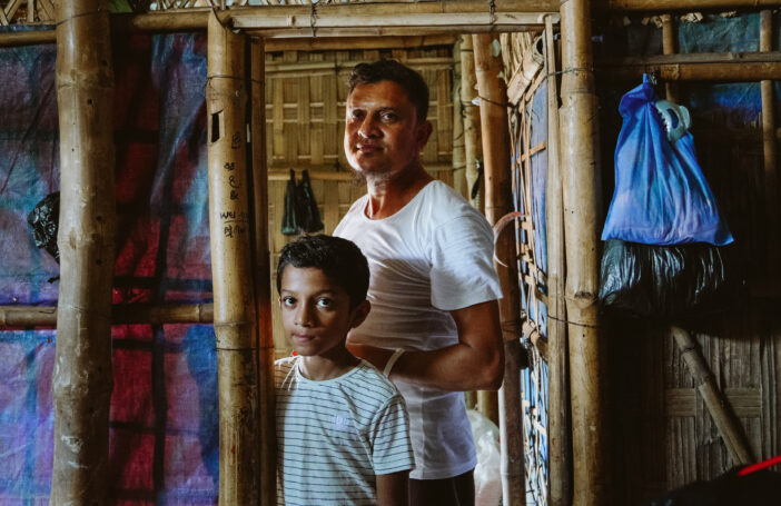 Noyum and son in their family shelter in the Rohingya refugee camps in Bangladesh (MSF-Victor Caringal)