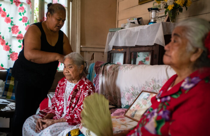 Caregiver brushing the hair of an elder in Tonga