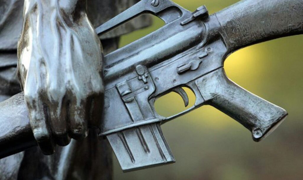 a close up of a gun on a statue