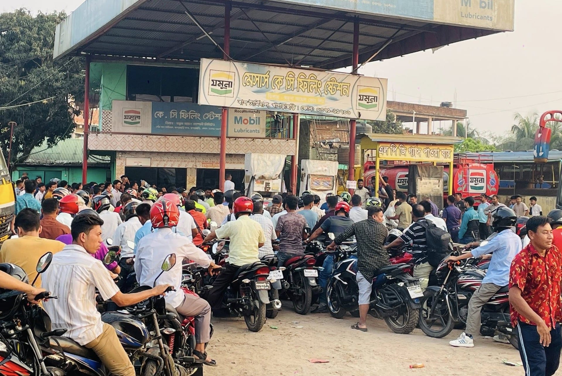 Motorcyclists queue for fuel in Dhaka, Bangladesh