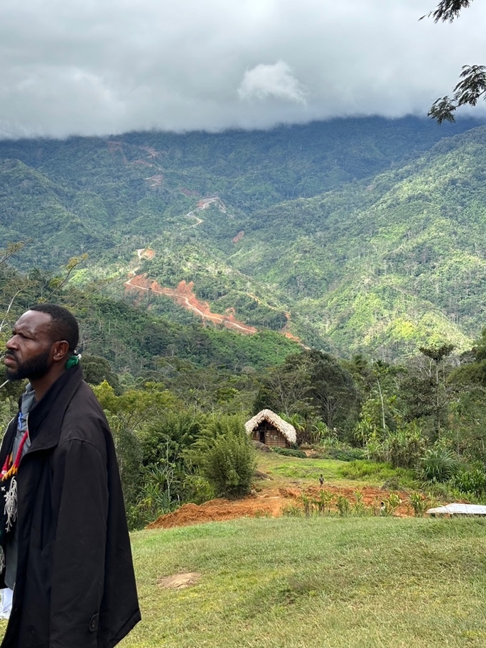 The Connect PNG road cut into the mountainside above Bema station.